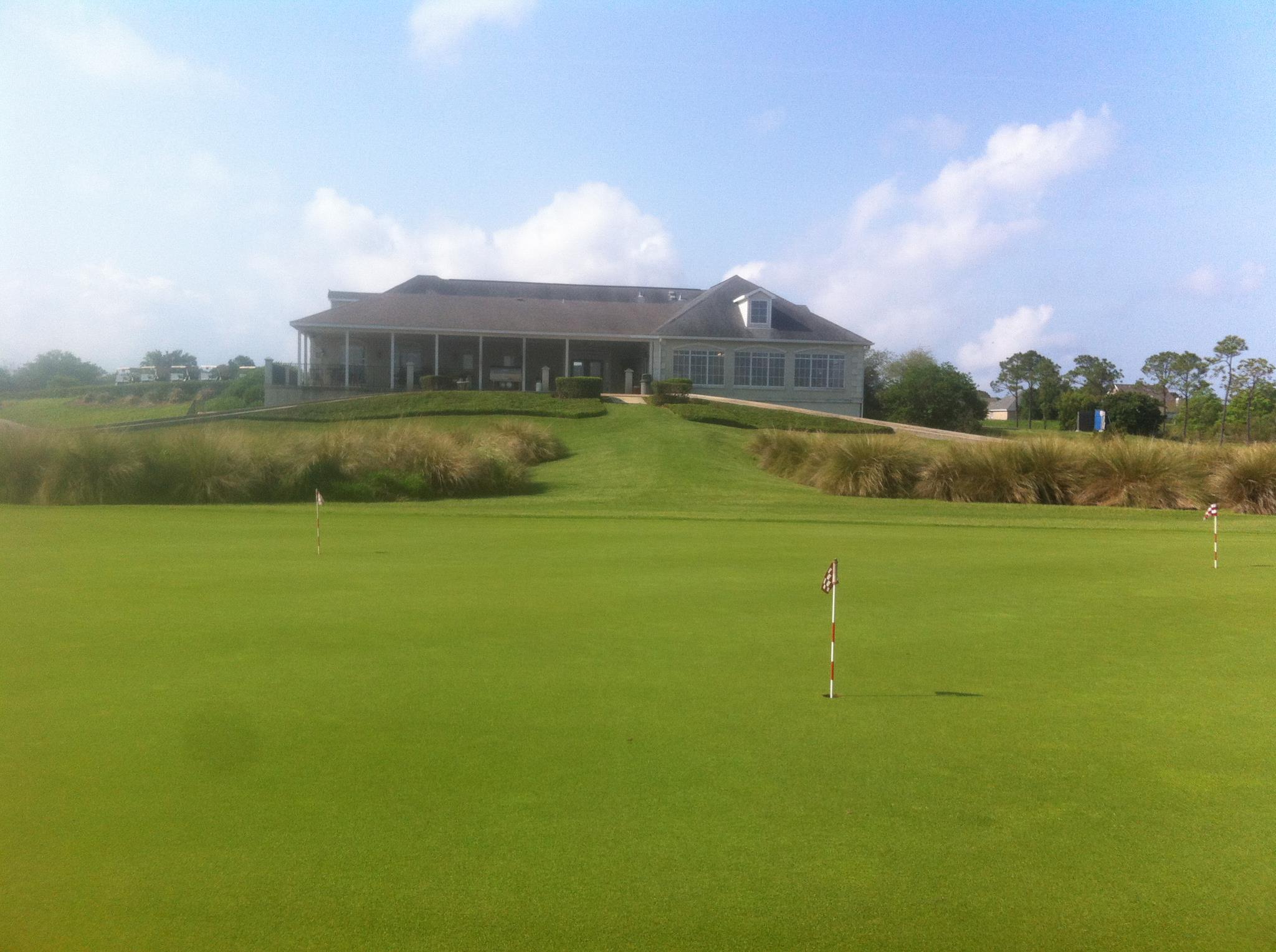 Image of golf ball on tee on grass.